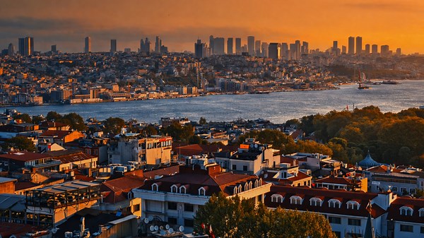 City skyline at sunset with river and urban architecture
