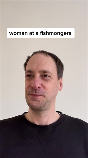 Woman Shopping at a Fishmonger's Market