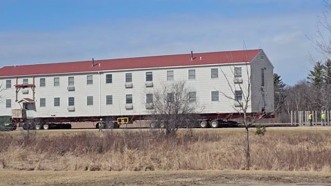 WWII barracks loaded onto truck to be moved in Fort McCoy, Wisconsin