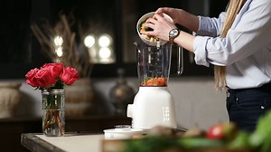 Adding chopped food to a blender - Free Stock Video