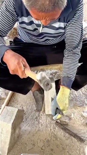 Shaping limestone block manually using hammer tool