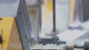 PVC Windows and Doors Manufacturing. PVC sections of windows and doors in a single frame - finishing process, releasing window for the next step. Cutting PVC profile with circular saw. PVC profiles