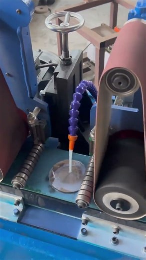 This is the process of sanding a piece of iron using a special sanding machine.