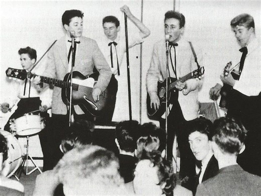 How old were The Beatles after their first number one hit?