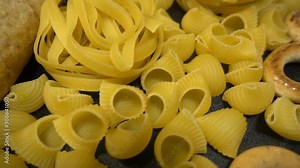 Background or texture of pasta close-up. Different types of pasta on the table shot close hd slow. Flour products