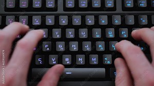 typing text different color keyboard two hands on the keyboard typing text backlit keyboard