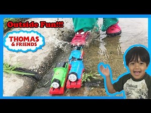 Ryan plays with Thomas and Friends toy trains outside!