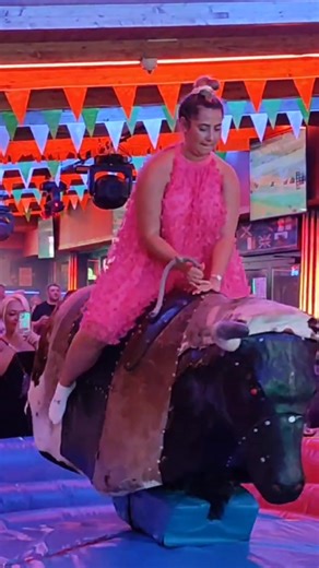 Thrilling Bull Riding Fun: Watch Her Enjoy the Mechanical Bull Ride