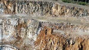 Opencast Mine Aerial View. Industrial terraces in a mining quarry. Open pit mining of dolomite. Excavation machinery of the dolomite mine. Extractive industry. Opencast mining.