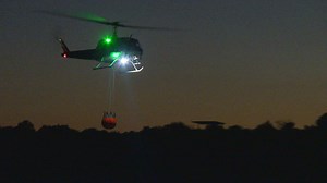 Firefighting helicopters take to the sky at night in Colorado