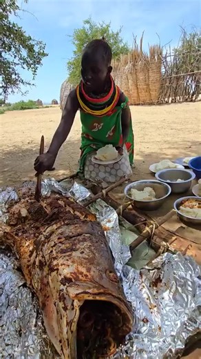 Turkana Woman Serves Delicious Nile Perch for Lunch