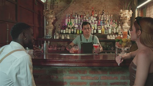 Waiter serving drinks to a couple in a bar - Free Stock Video