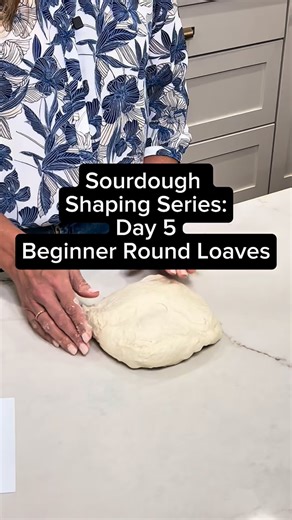 Heather Woodland - Sourdough for Beginners on Instagram: "Day 5 of shaping 🍞 Another easy way to shape a round loaf — and this one is very beginner-friendly 🙌 Start with your dough gently stretched out on the counter. Place one hand in the center, then lift and tuck the dough into itself as you move around the circle. Flip it over, rotate it on the counter to build a little surface tension… and boom 💥 You’ve got a nice, tight round loaf. No fancy moves. No stress. No “why does my dough hate m
