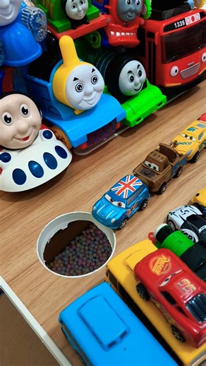 blue bus pushing brown tow mater and yellow dinoco cars in pit, pixar cars mcqueen