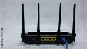 Wireless WIFI Router With Blue Patch Cord In WAN Connector On Office Table Background. Zoom In Dolly Slider Shot.