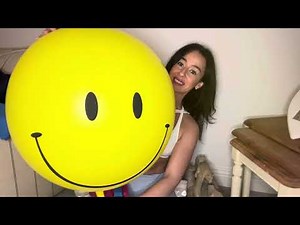 Blowing up a big yellow smiley face balloon and deflating