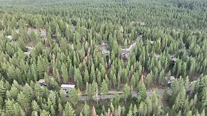 Aerial video of the Sierra Nevada mountains surrounded by trees, a tourist area. U.S