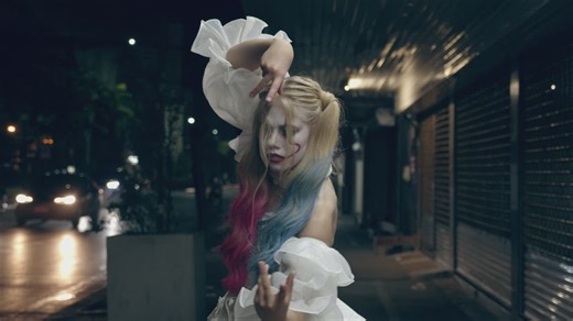 Woman in a Harley Quinn costume dancing on the street - Free Stock Video