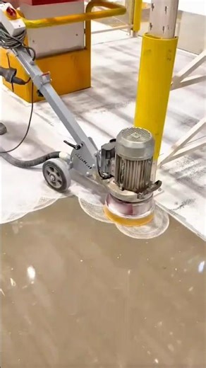 Industrial Floor Grinder Polishing a Large Concrete Surface with Electric Motor