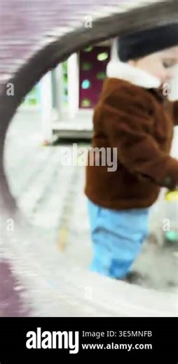 Child reaching for yellow toy on playground Stock Video Footage - Alamy