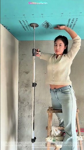 Female Worker Installing Ceiling Gypsum Boards: A Skilled Craft in Construction