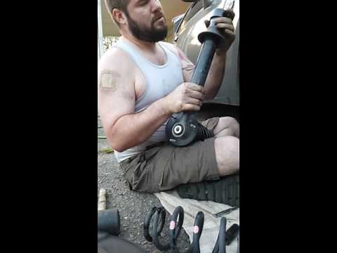 Strut disassembly with no spring compressor.