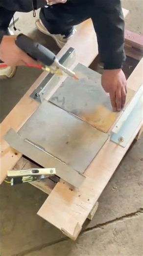 Man using hand held laser welder on metal plate