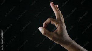 Gesture OK on black background. hand showing OK Sign. Positive Gesture, Sign, Symbol, Success, Good.