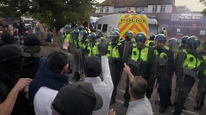 Protesters smash up police vans during clashes outside migrant hotel in Epping