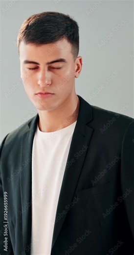 Fashion model, photoshoot and man in studio on set for magazine brand, picture and stylish. Photography, white background and person with flash, camera and designer clothes with trendy apparel