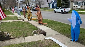 Watch out for that T-Rex! Group bringing cheer during pandemic by walking as inflatable animals