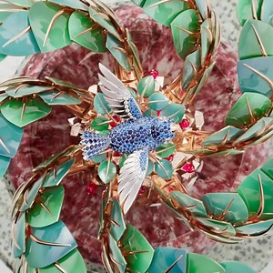 3.3K views · 135 reactions | Van Cleef & Arpels puts its High Jewelry expertise at the service of time in the Apparition des Baies automaton, whose lacquered rose-gold leaves open and close, revealing the flight of a precious bird. #VanCleefArpels #VCAExtraordinaryObjects | Van Cleef & Arpels | Facebook