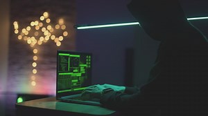 Hacker working with a laptop in a dark room - Free Stock Video