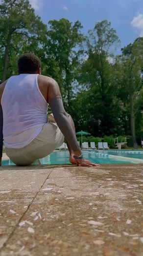 TransTape™️ on Instagram: "Feel the water against your chest with TransTape® - over 8 years of creating and perfecting the binding, packing, tucking, and lifting solution you've been waiting for. ☀️🌊 (@bvncsan he/they) ⁠ •⁠ #transtape #chestbinding #hehim #theythem #trans #enby #nonbinary #lgbtq⁠ ⁠ ( a black transman gets into the pool wearing a white tank top and beige shorts. He then swims away from the pool edge)"