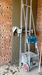 This is a wall plastering machine from China. It's compact, easy to operate, and lightweight.