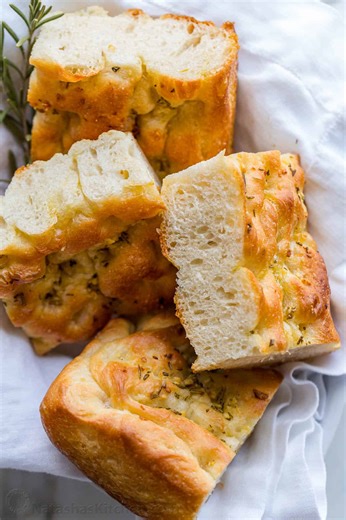 This Focaccia Bread recipe has the most crisp chewy crust, airy soft center, and amazing garlic rosemary topping. 🌿🥖 | NatashasKitchen.com