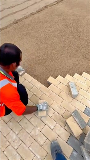 Skilled Worker Carefully Installing Interlocking Paving Bricks for a Durable Walkway