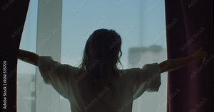 Happy woman wear dressing gown come to big window open lace curtain look outside, young beautiful lady enjoy view feel fresh motivated start new day in modern home, good morning lifestyle concept