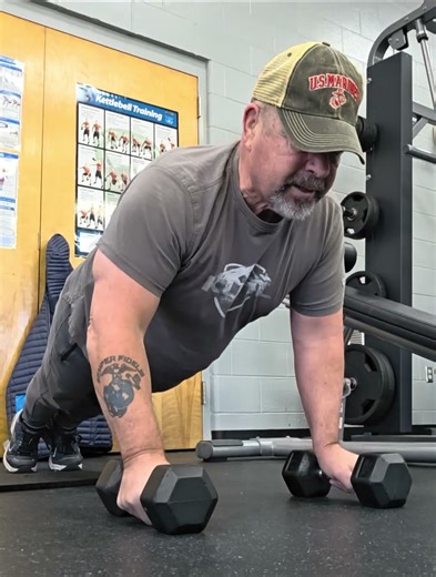 Pushups with hands on dumbbells using good form