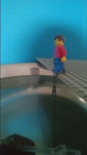 a man has fallen into a river in lego. lego city