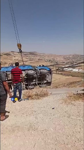 Overturned Blue Truck Recovery with Crane Assistance