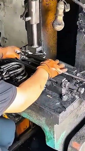 Using heavy duty hydraulic press to bend steel rods into u-bolts for mechanical industrial fastening