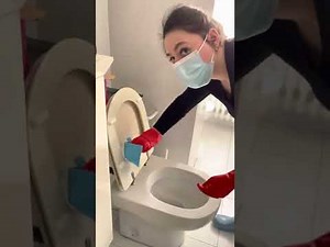 Cleaning the bathroom in rubber gloves and rain boots
