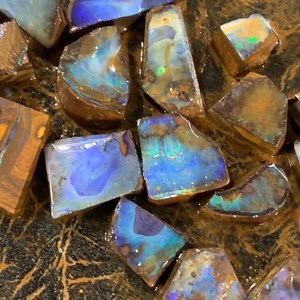 12 reactions | Fresh off the wheels, still soaking in that lovely Boulder sludge water  These pieces had just been worked to remove/grind away the excess rock from the opal to reveal the opals face within #workinprogress #boulderopal (not for sale) | Signature Opal | Facebook