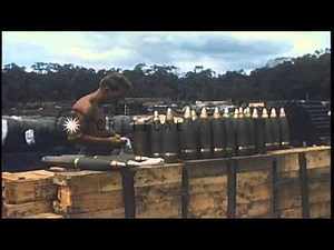 A US soldier prepares powder charges on a 105 mm howitzer and works on shells at ...HD Stock Footage