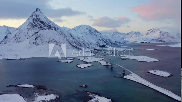 4k drone flight moving to the side footage (Ultra High Definition) of Fredvang bridge and Volandstind peak on background, Norway, Europe. Gorgeous morning scene of Lofoten Islands archipelago.