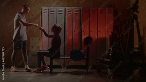 Girl get ready for boxing training in the locker room. Red Neon light