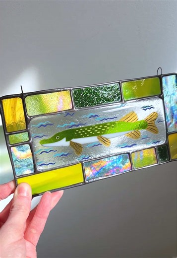 The process behind making the little pike stained glass panel. From cutting glass, grinding it to shape, cleaning and then painting and fusing. Next we foil it all up and solder it together, add a nice patina and polish and we’re good to go!!! I have been loving mixing these different forms of glass art. Fusing glass has awakened something in my creative self and I am so grateful for it. And fish are so fun to make out of glass. #stainedglass #fusedglass #glassart #canadianartist