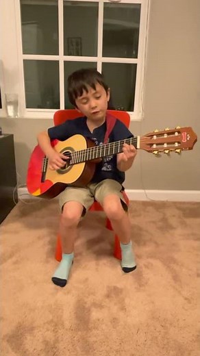 5 year old boy plays and sings Rainbow Connection on guitar