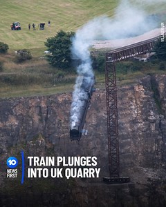 RUNAWAY TRAIN FALLS OFF CLIFF Onlookers in a small UK village have watched in awe as a black steam train plummeted to its demise in a deep quarry. But before you get too concerned, it's all part of a movie stunt. The scene is part of an upcoming Mission: Impossible 7 movie, with the remarkable set - including a 330m railway line - taking around 4 months to fully construct. | 10 News
